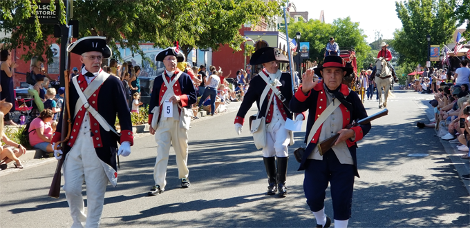 Sacramento Chapter SAR Color Guard marching down the street in authentic uniform outfits during the Folsom Parade