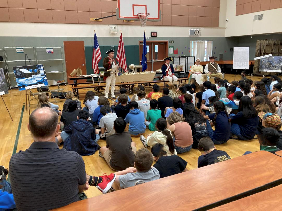 Volunteers of the Sacramento Chapter School Guard standing in authentic Revolutionary War uniforms and period outfits